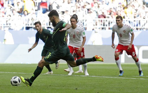 The Associated Press BY A MILE: Australia's Mile Jedinak scores his side's opening goal from the penalty spot during the Group C draw against Denmark Thursday in the 2018 FIFA World Cup Samara, Russia. The Danes are three points ahead of the Aussies as the two teams next play Tuesday against France and Peru, respectively, to determine who will advance to the second round.