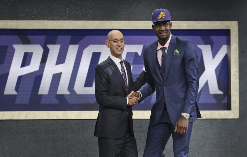 The Associated Press FRONT AND CENTER: Arizona's Deandre Ayton, right, poses with NBA Commissioner Adam Silver after he was picked first overall by the Phoenix Suns during the NBA draft in New York Thursday.