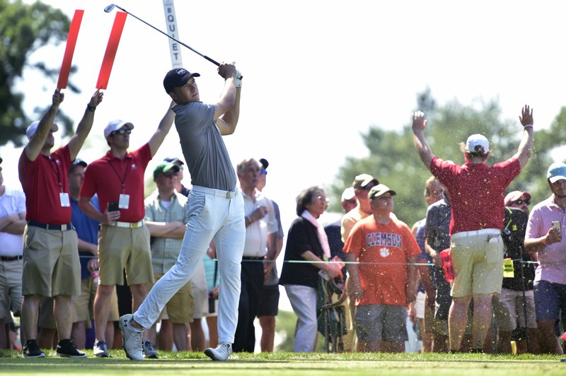 The Associated Press QUIET PLEASE: Jordan Spieth watches his tee shot on the 11th hole during the first round of the Travelers Championship at TPC River Highlands on Thursday in Cromwell, Conn. Speith is tied with Zach Johnson for the first-day lead with a 7-under 63.