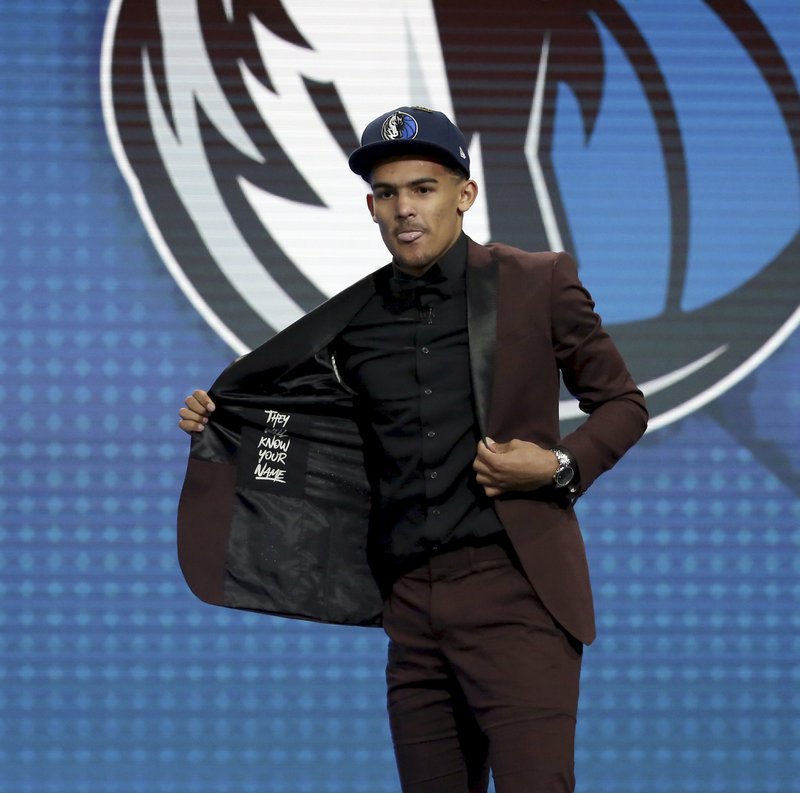 The Associated Press NO. 5 SOONER: Oklahoma's Trae Young poses for pictures after he was picked fifth overall by the Dallas Mavericks during the NBA draft in New York Thursday.