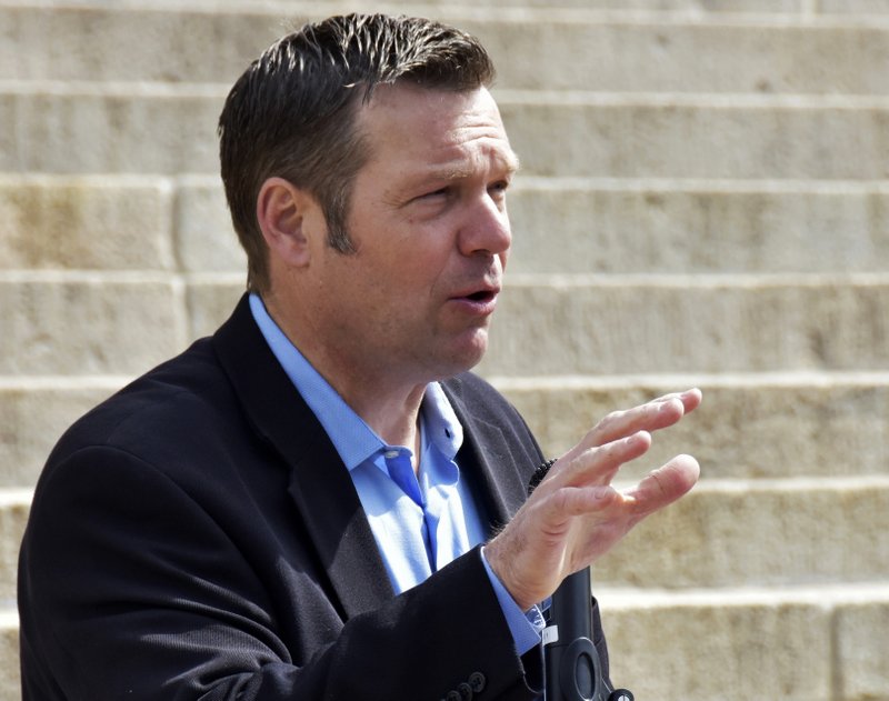 FILE - In this April 20, 2018, file photo, Kansas Secretary of State Kris Kobach speaks during a rally in Topeka, Kan. The American Civil Liberties Union of Kansas filed a federal lawsuit Tuesday, June 19, 2018, against Kobach challenging a multi-state voter registration database it claims exposed sensitive information including partial Social Security numbers from nearly a thousand state voters. (AP Photo/Mitchell Willetts, File)