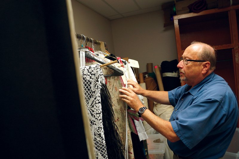 Steve Frye, producer of the Searcy Summer Dinner Theatre and chairman of the Harding University Theatre Department, looks through the costumes for the upcoming production of Moon Over Buffalo. It is set for 7:30 p.m. Thursday through July 1 and July 5-7 in the Ulrey Performing Arts Center on campus. Tickets, at $32 each or $17 for the show only, are available at hardingtickets.com or by calling (501) 279-4276.
