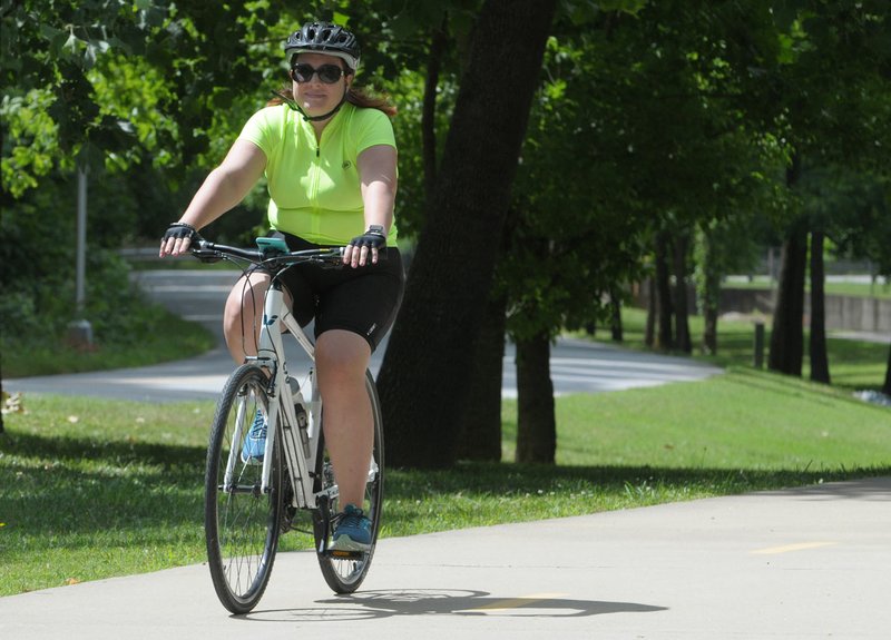 NWA Democrat-Gazette/DAVID GOTTSCHALK Kylie Gatewood rides Friday on the Razorback Greenway in Bentonville. Gatewood was participating in the Great Cycling Challenge and raising money for children's cancer care and research.