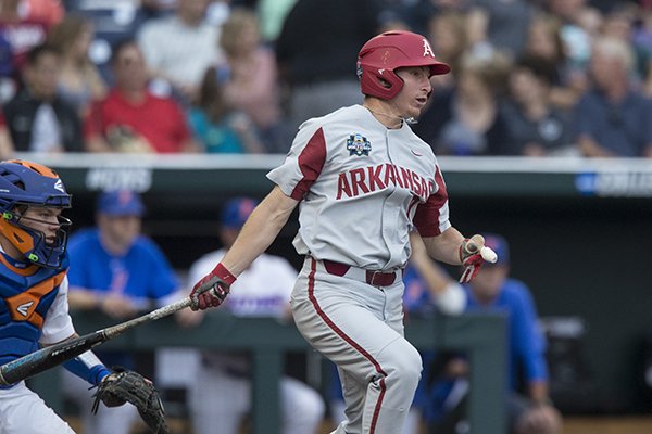 Arkansas shortstop Jax Biggers bats during a College World Series game against Florida on Friday, June 22, 2018, in Omaha, Neb.