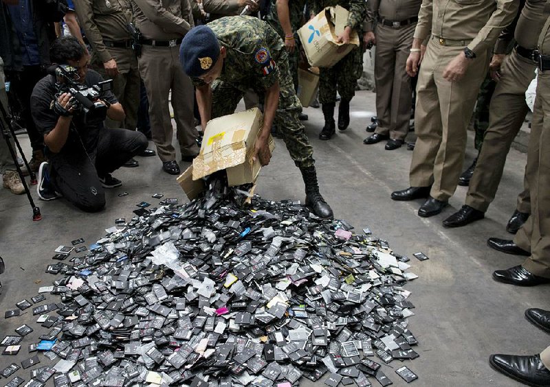 A Thai police officer piles up electronic waste during a raid last week at a factory in Bangkok accused of illegally importing and processing the potentially toxic material.  