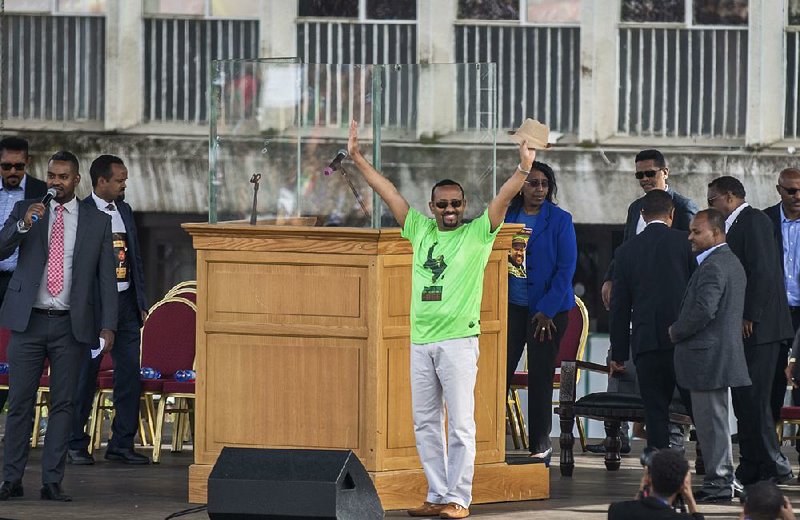 Ethiopia’s Prime Minister Abiy Ahmed greets the crowd Saturday at a rally in the nation’s capital, Addis Ababa. Just after he spoke to the gathering, a grenade exploded nearby. 