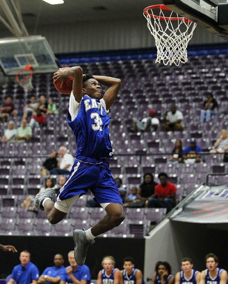 The East’s Travonta Doolittle rises for a dunk during the fifth period of the East’s 124-87 victory in the Arkansas High School Coaches Association Boys All-Star basketball game Saturday at the Farris Center in Conway. Doolittle finished with 24 points, 5 rebounds and 2 blocks. See more photos at arkansasonline.com/galleries. 