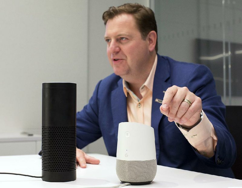 In this photo taken earlier this month, Gareth Gaston, executive vice president and head of Omnichannel Banking at U.S. Bank, discusses voice assistant banking with an Amazon Echo, left, and a Google Home, right, in New York. 