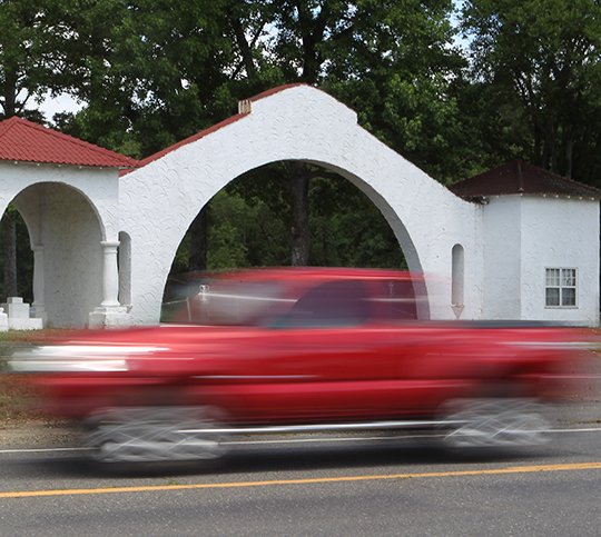 A motorist drives past the entrance to the former Fountain LakeResort at 3999 Park Avenue Thursday, June 21, 2018. Mountain Valley Water has purchased the property. (The Sentinel-Record/Richard Rasmussen)