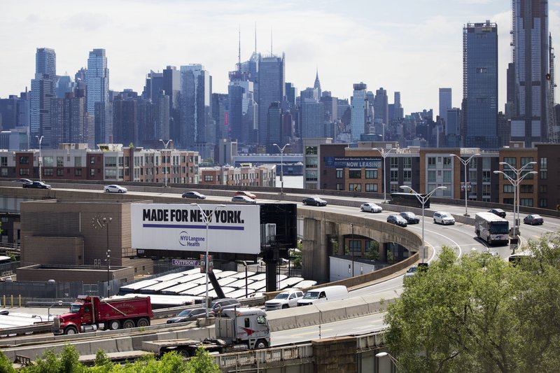 Traffic spirals up and down a section of Route 495 to the Lincoln Tunnel, Thursday, June 21, 2018, in Weehauken, N.J. An estimated two-and-a-half-year rehabilitation project on a separate section of 495 will create &quot;severe congestion&quot; according to the state's Department of Transportation. The New York City skyline is in the background. (AP Photo/Mark Lennihan)