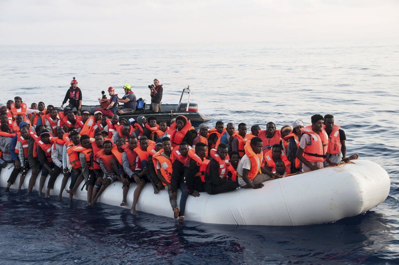 In this photo taken on Thursday, June 21, 2018, migrants on a rubber boat are being rescued by the ship operated by the German NGO Mission Lifeline in the Mediterranean Sea in front of the Libyan coast. Italy's interior minister says Malta should allow a Dutch-flagged rescue ship carrying 224 migrants to make port there because the ship is now in Maltese waters.  (Hermine Poschmann/Mission Lifeline via AP)