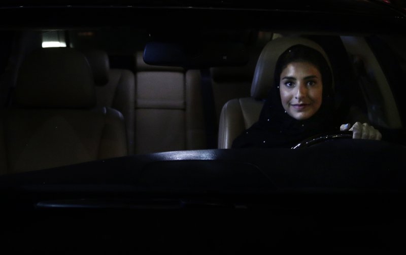 Hessah al-Ajaji sits in her car on the capital's busy Tahlia Street after driving for the first time in Riyadh, Saudi Arabia, Sunday, June 24, 2018. Saudi women are in the driver's seat for the first time in their country and steering their way through busy city streets just minutes after the world's last remaining ban on women driving was lifted on Sunday. (AP Photo/Nariman El-Mofty)