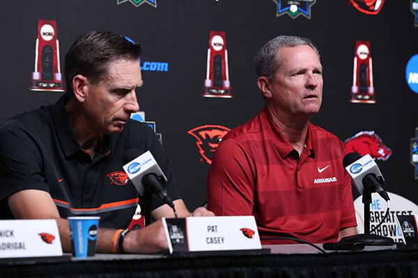 Arkansas coach Dave Van Horn, right, answers a question while Oregon State coach Pat Casey listens during a news conference Sunday, June 24, 2018, at the College World Series in Omaha, Neb. The Razorbacks and Beavers will play for the national championship beginning Monday at 6 p.m.