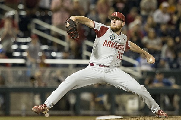 Matt Cronin, Arkansas reliever, throws the final strike of the game to defeat Florida 5-2 Friday, June 22, 2018, in the semifinals of the NCAA Men's College World Series at TD Ameritrade Park in Omaha.