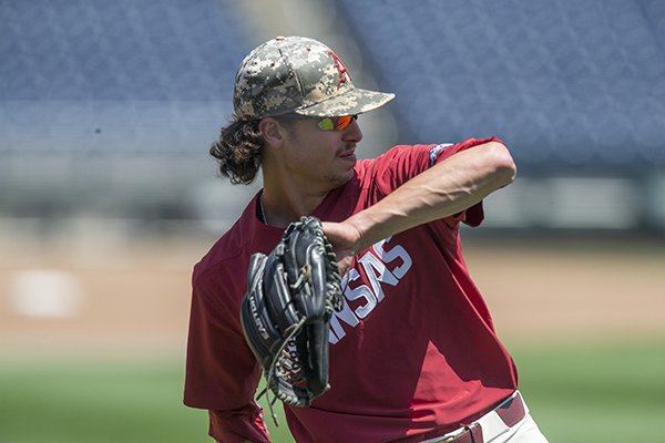 Blaine Knight, Arkansas pitcher, throws Sunday, June 24, 2018, during practice ahead of the championship final of the NCAA Men's College World Series at TD Ameritrade Park in Omaha.
