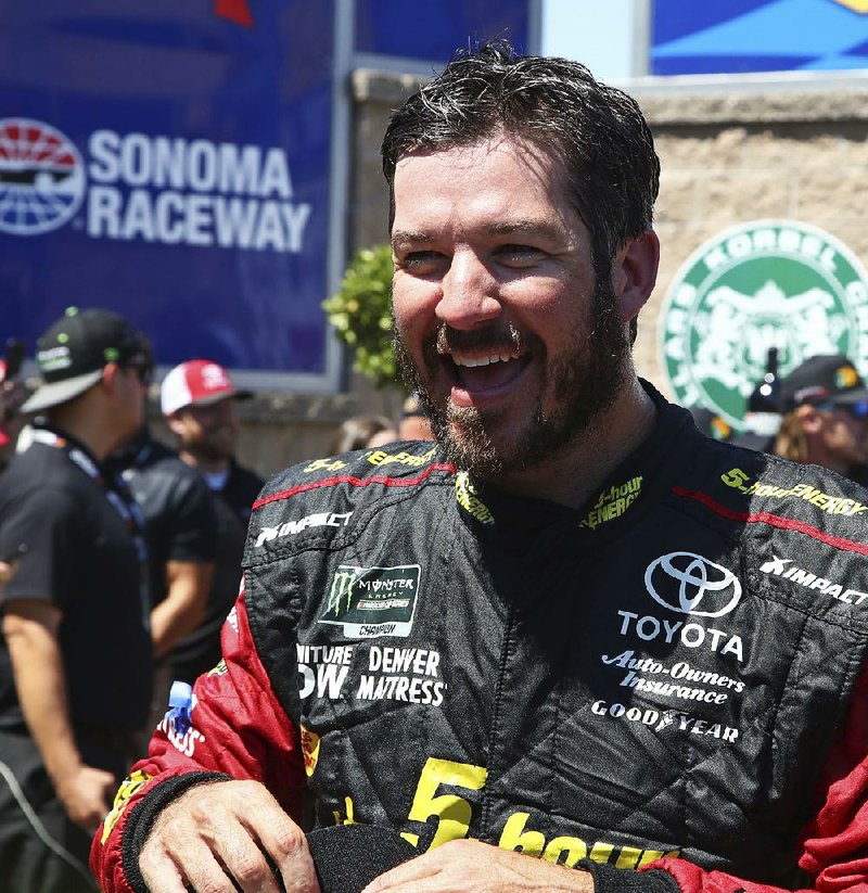 Martin Truex Jr. smiles after winning a NASCAR Sprint Cup Series auto race Sunday, June 24, 2018, in Sonoma, Calif. 