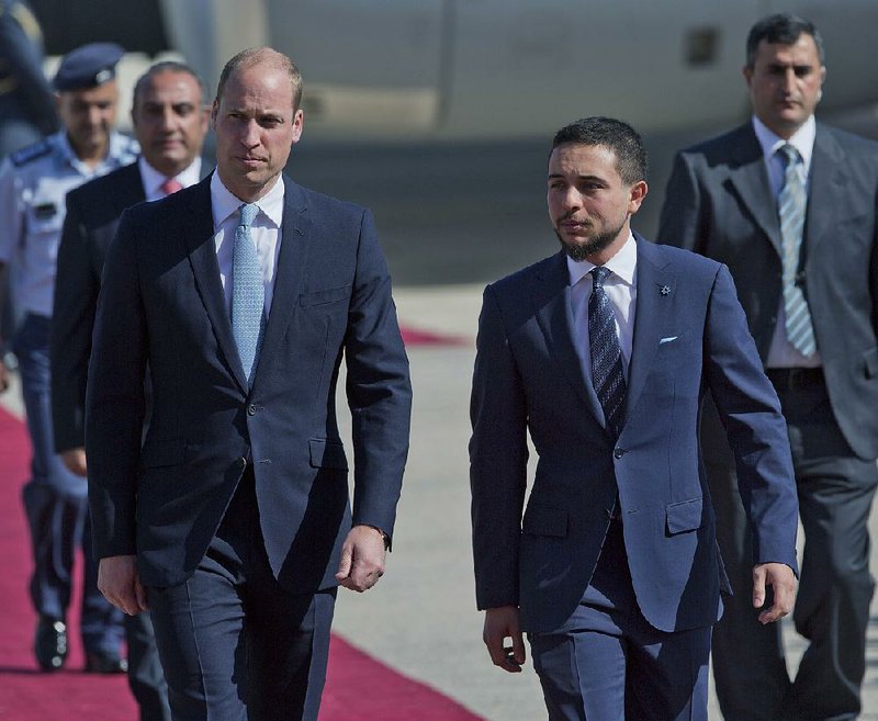 Jordanian Crown Prince Hussein (right) receives Britain’s Prince William after his arrival at Marka Airport in Amman, Jordan, on Sunday.  