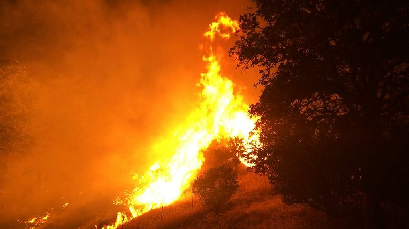 The Pawnee Fire, one of four wildfires, burns Sunday northeast of Clearlake Oaks, Calif., in this photo provided by the California Department of Forestry and Fire Protection.  