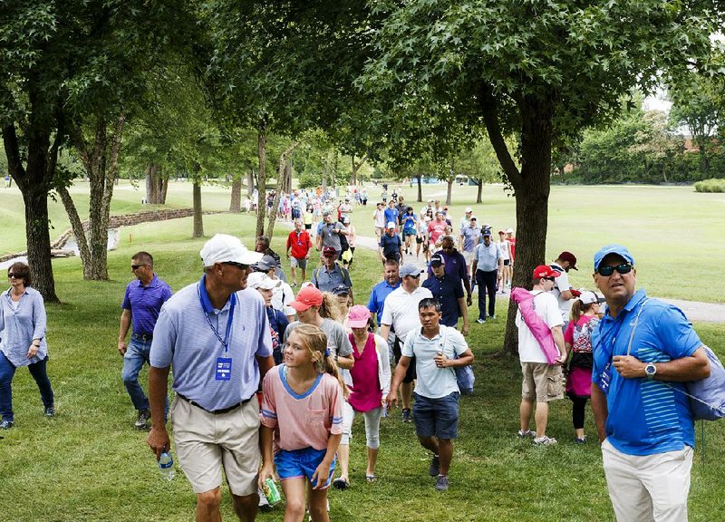 Fans follow Nasa Hataoka and her group as they make their way through the seventh fairway during the final round of the LPGA Northwest Arkansas Championship on Sunday at Pinnacle Country Club in Rogers. The tournament, which was started in 2007, is expected to last another two years before Walmart’s contract as the title sponsor expires. 
