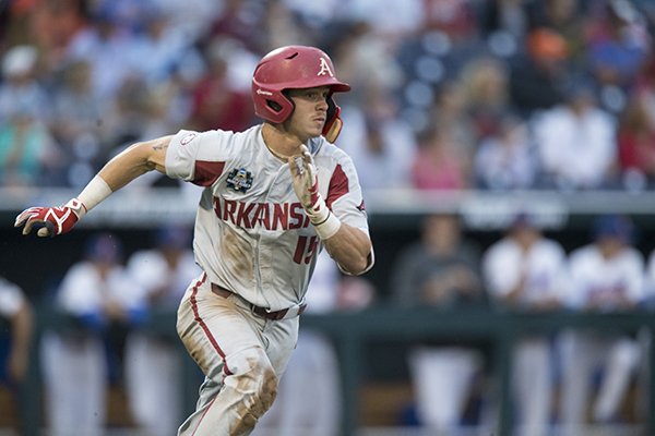 Arkansas third baseman Casey Martin runs after recording a hit during a College World Series game against Florida on Friday, June 22, 2018, in Omaha, Neb.