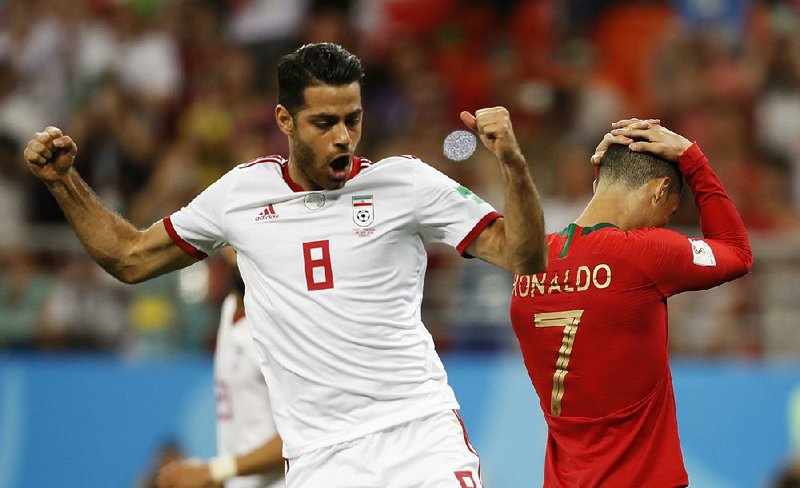 Portugal’s Cristiano Ronaldo (right) reacts after failing to score on a penalty shot as Iran’s Morteza Pouraliganji reacts during Monday’s World Cup match between Iran and Portugal at the Mordovia Arena in Saransk, Russia. (AP Photo/Francisco Seco)