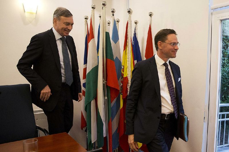 Hans Dietmar Schweisgut (left), European Union ambassador to China, and European Commission Vice President Jyrki Katainen leave a news conference in Beijing on Monday after the EU’s governing body said Europe and China will form a group to update global trade rules to address technology policy. 