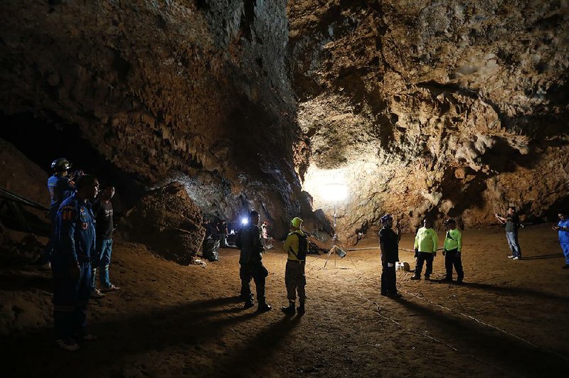 Rescue teams gather Monday in a deep cave where a group of boys disappeared in Chiang Rai, northern Thailand.  
