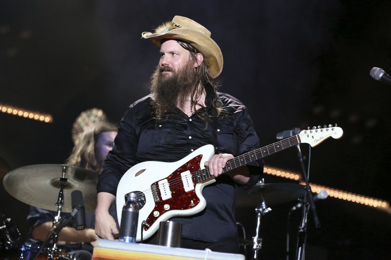 FILE - In this June 9, 2018, file photo, artist Chris Stapleton performs at the 2018 CMA Music Festival at Nissan Stadium in Nashville, Tenn. Stapleton is joining performers for the 33rd annual Farm Aid. Organizers announced Monday, June 25, the benefit for farmers will take place Sept. 22 at the Xfinity Theatre in Hartford, Conn. (Photo by Laura Roberts/Invision/AP, File)
