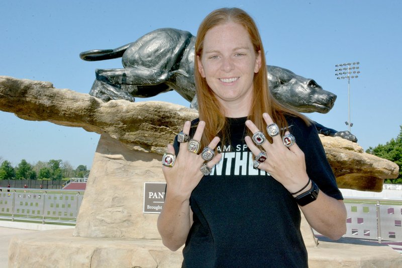 Graham Thomas/Herald-Leader Siloam Springs alum and assistant soccer and cross country coach Abby Ray has won 11 state championships in five years of coaching at her alma mater. Ray, seen here with 10 state championship rings &#x2014; four in girls cross country, four in girls soccer and two in boys soccer &#x2014; will receive No. 11 and the fifth for girls soccer this fall.