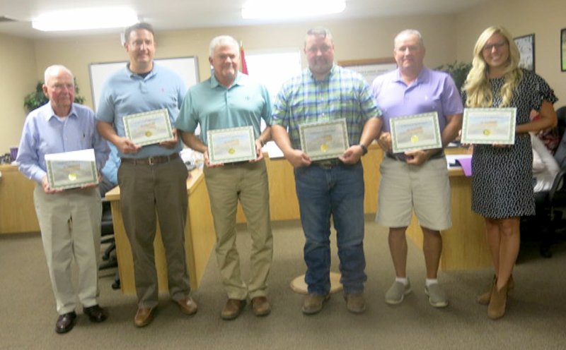 Westside Eagle Observer/SUSAN HOLLAND John Edwards, Clay McGill, Paul Hively, Chuck Mayo, Jerry Foster and Tori Bognar display certificates they received at the June 18 meeting of the Gravette school board. Certificates were awarded in appreciation for their efforts in the recent millage campaign conducted by the Gravette school district. Jennifer Batie, Heidi Larson, Mike Pehosh, Daniel Rice and Jim Singleton also received certificates but were not present at the meeting.