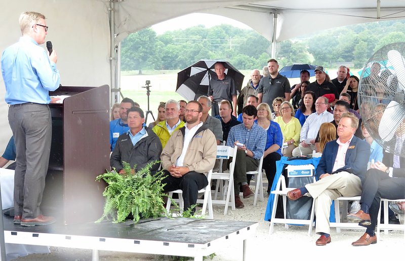 Westside Eagle Observer/RANDY MOLL Todd Simmons, CEO and vice chairman of Simmons Foods (left), addresses guests and visitors at the new Simmons Processing Plant dedication ceremony on a rainy Wednesday, June 20, 2018, morning. The new facility is beng built along Arkansas Highway 59 between Gentry and Decatur.