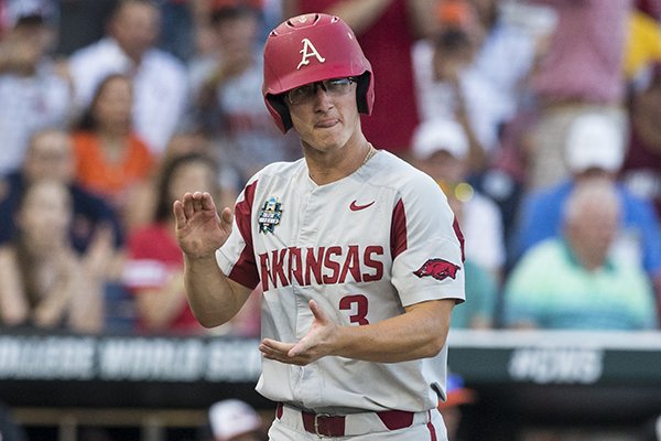 Arkansas first baseman Jared Gates claps his hands as he scores a run during the fifth inning of a College World Series finals game against Oregon State on Tuesday, June 26, 2018, in Omaha, Neb.