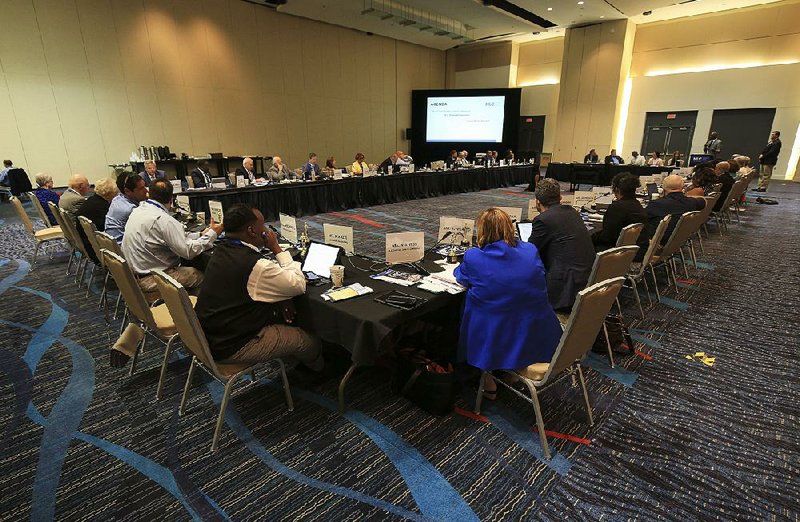 Members of the National League of Cities’ board meet Tuesday morning at the Statehouse Convention Center in Little Rock during the group’s summer conference. 