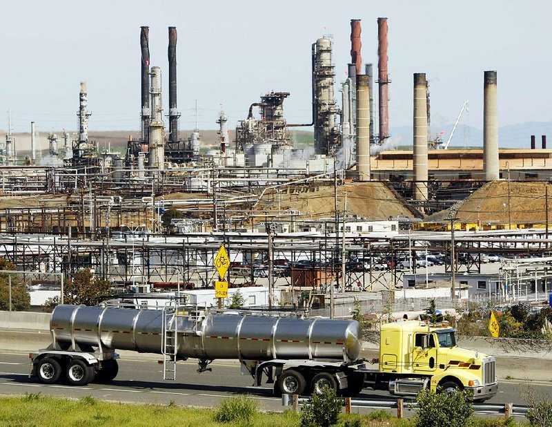 A tanker passes the Chevron oil refinery in Richmond, Calif., in this 2010 photo. Chevron was one of the oil companies two California cities targeted in a lawsuit over climate-change costs.