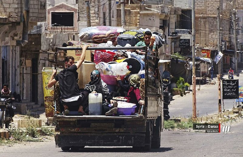 A truck with people and their belongings flee from Daraa in southern Syria last week. Fighting continued Tuesday as Syrian forces pushed deeper into the province. 