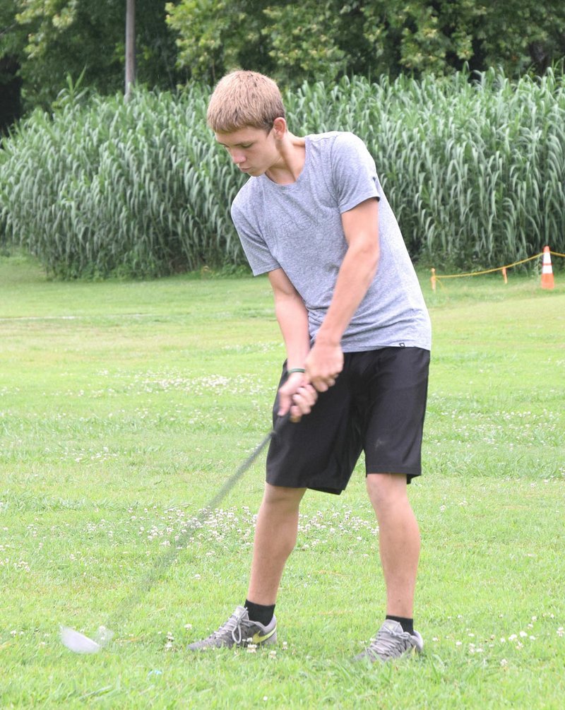 Rick Peck/Special to McDonald County Press Michael Laymon, 13, of Bushton, Kan., hits a shot at the Elk River Golf Course while visiting his grandmother in Noel last week.