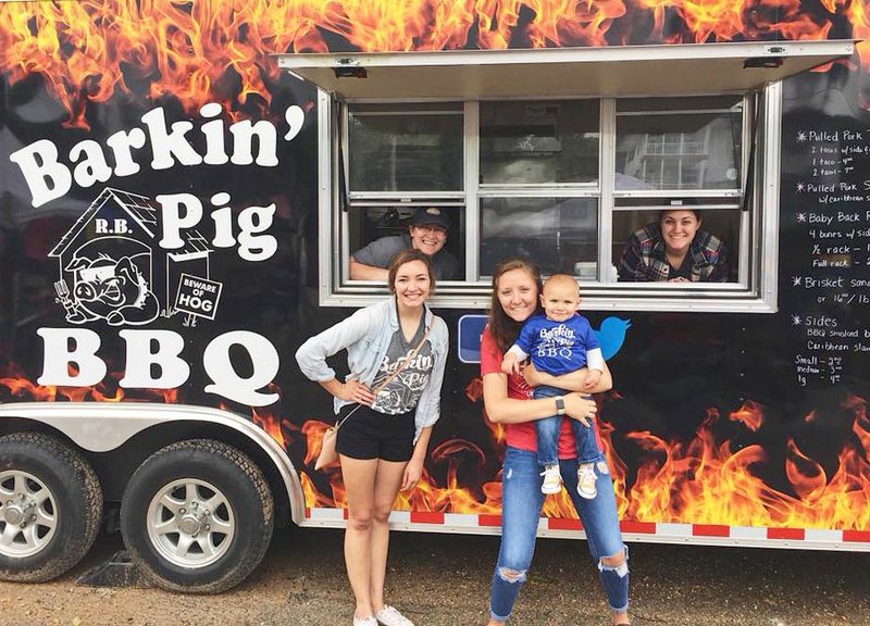Courtesy Photo The crew of Barkin' Pig BBQ will be on hand at the Noel First Friday on July 6. The event will feature good food, vendors, live music, a water slide and more. Activities will take place on Main Street in downtown Noel. Here, the crew is ready to serve up some good barbecue. Front, right, daughter Emily Franklin holds the Franklins' grandson, Oakley, while Emily's friend, Brooke Frazier, looks on. Right back, the Franklins' other daughter, Kylie Alwardt, poses in the window on the right, while co-owner Amy Franklin looks out the window on the left.