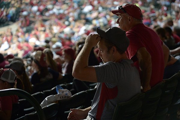 Austin McLennan (left) and his father, Gary McLennan, both of Rogers, react Wednesday, June 27, 2018, as Arkansas loses the lead in the ninth inning while watching as the University of Arkansas baseball team competes in the College World Series Final Series with Oregon State in Omaha, Neb., during a watch party at Baum Stadium in Fayetteville. Arkansas lost, 5-3.