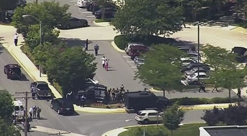 In this frame from video, people leave the Capital Gazette newspaper after multiple people have been shot on Thursday, June 28, 2018, in Annapolis, Md. (WJLA via AP)

