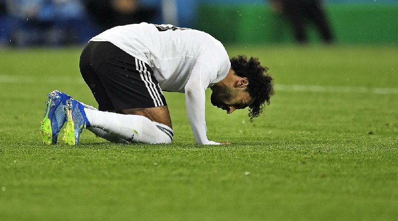 Egypt's Mohamed Salah prays on the ground after scoring a penalty during the group A match between Russia and Egypt at the 2018 soccer World Cup in the St. Petersburg stadium in St. Petersburg, Russia on June 19. (AP Photo/Martin Meissner)