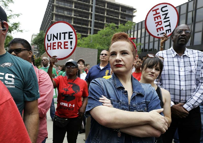 Amanda Hammock, a Delaware County, Pa., Democratic Party activist, is dressed as Rosie the Riveter as she attends a protest Wednesday by the Philadelphia Council AFL-CIO. The protesters denounced the Supreme Court ruling on collective bargaining.  