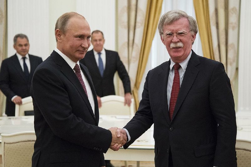 Russian President Vladimir Putin (left) and U.S. National security adviser John Bolton meet Wednesday in the Kremlin.  