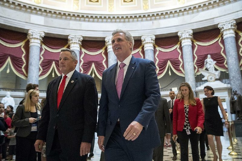Rep. Bruce Westerman (left), R-Ark., and House Majority Leader Kevin McCarthy of California walk to the House floor on Capitol Hill before Wednesday’s vote on the immigration bill. Westerman voted against the measure. 
