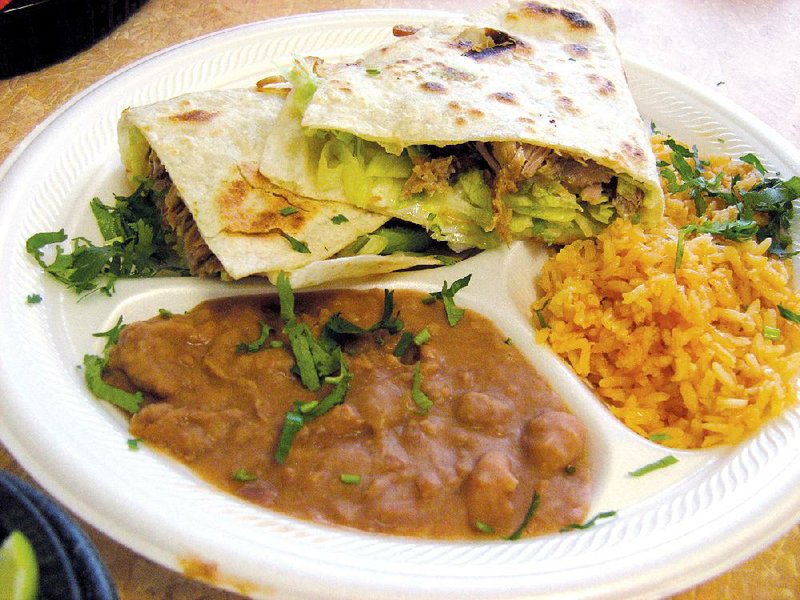 Taqueria El Primo in Sherwood serves quesadillas filled with one’s choice of meat, lettuce, cheese, tomato and avocado. Here it’s made with carnitas, along with rice and beans. 