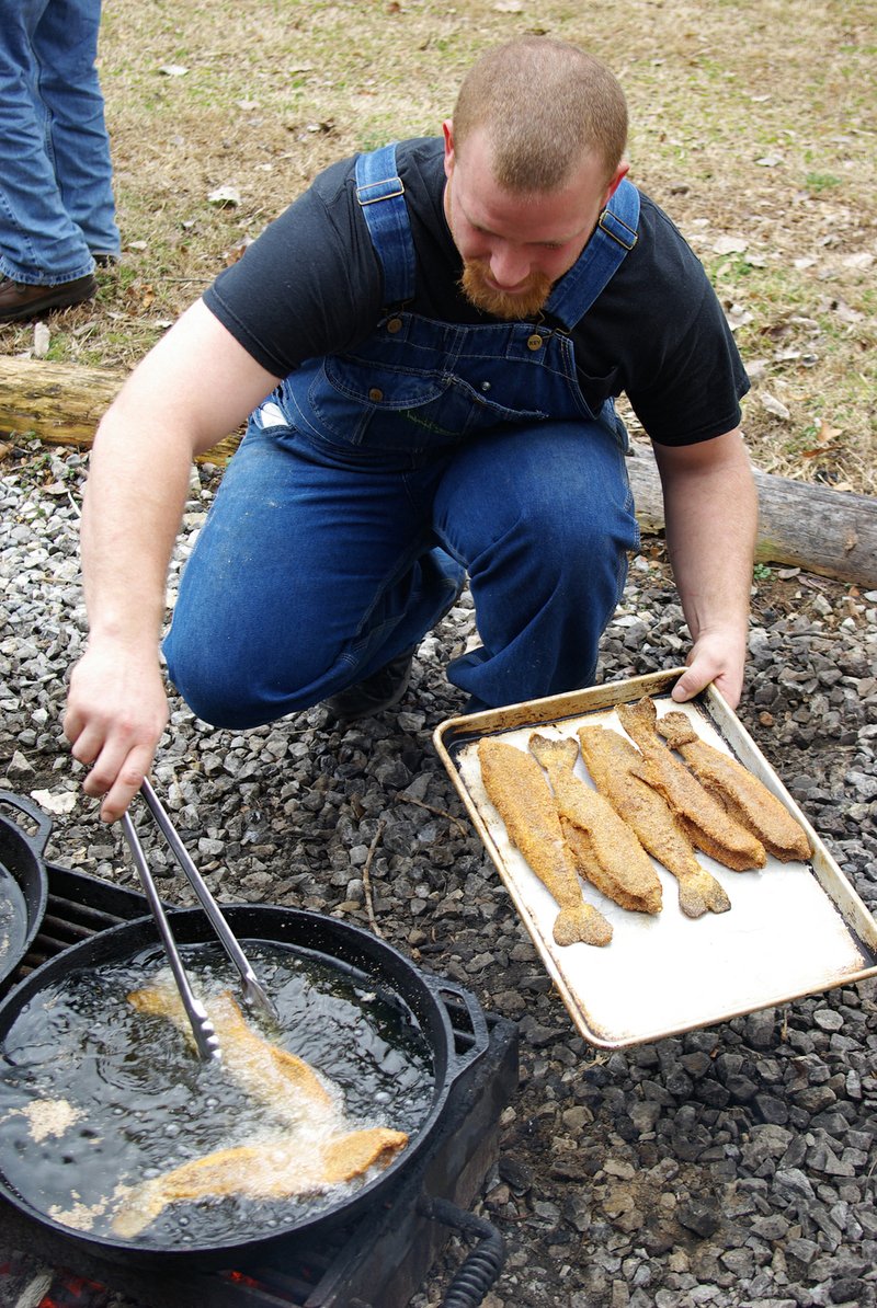 Dennis Coker at Gaston’s White River Resort prepares a noontime meal of fresh trout for guests fishing with guides who work at this world-famous trout-fishing destination.