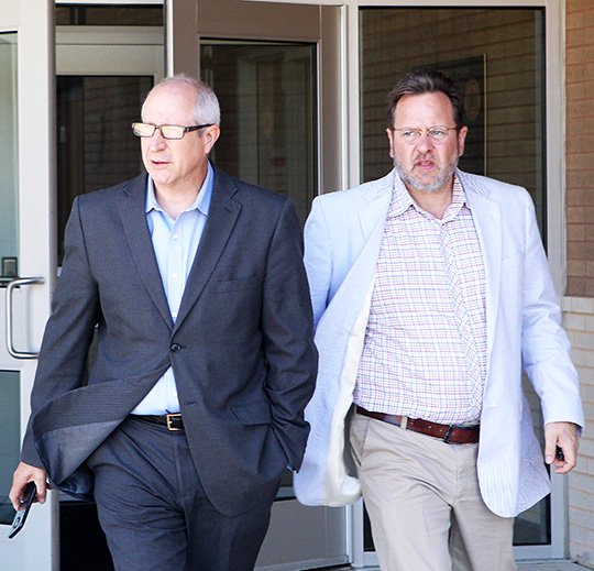 The Sentinel-Record/Richard Rasmussen OUT ON BAIL: State Rep. Mickey Gates, R-District 22, left, exits the Garland County Detention Center Thursday with attorney Joe Churchwell after being released on bond. The Arkansas State Police arrested Gates earlier that morning on felony charges of willfully failing to file tax returns.