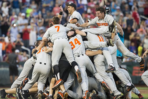 Oregon State players dog pile after winning the national championship on Thursday, June 28, 2018, at the College World Series in Omaha, Neb. 