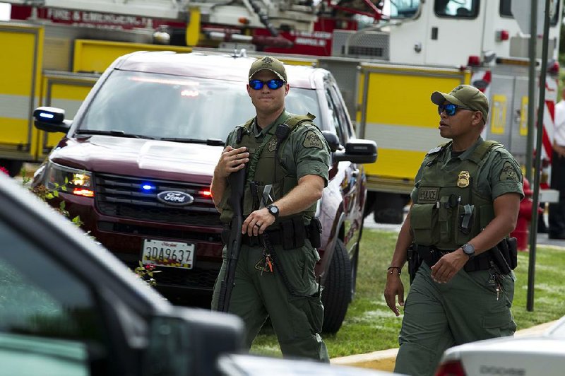 Maryland law enforcement officers patrol the area Thursday after a gunman opened fire in the Capital Gazette newspaper offices in Annapolis.  