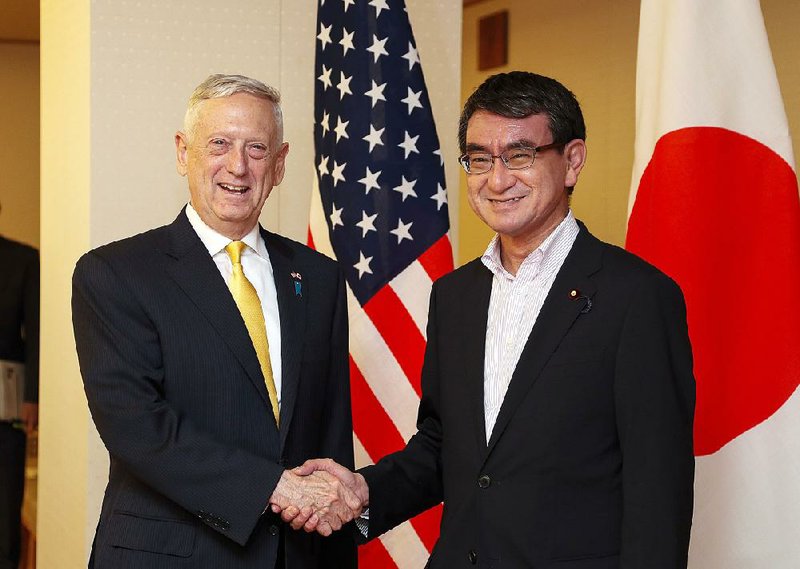 U.S. Defense Secretary James Mattis and Japanese Foreign Minister Taro Kono stop for a photo before the start of their meeting Friday at the Foreign Ministry in Tokyo.  
