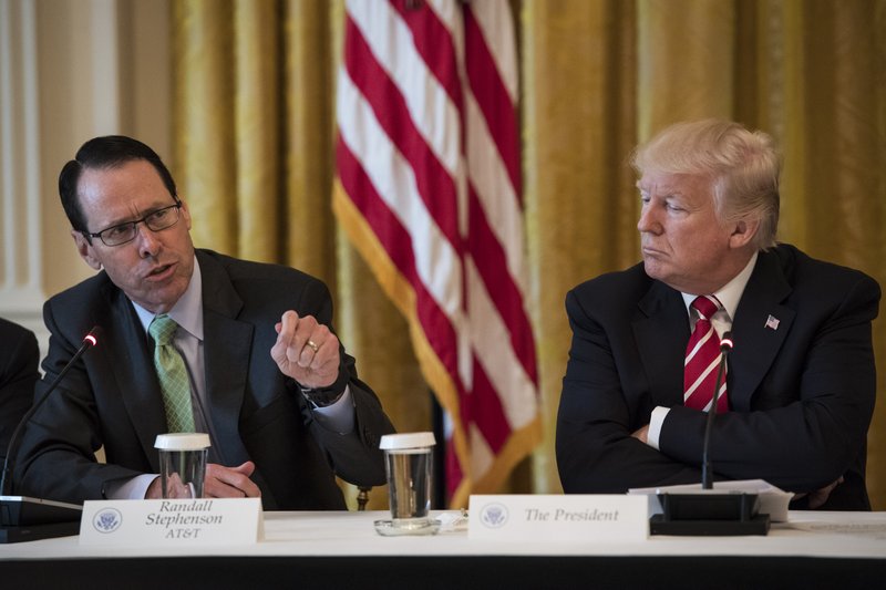 President Donald Trump listens to AT&T CEO Randall Stephenson during an event at the White House in Washington in 2017. 